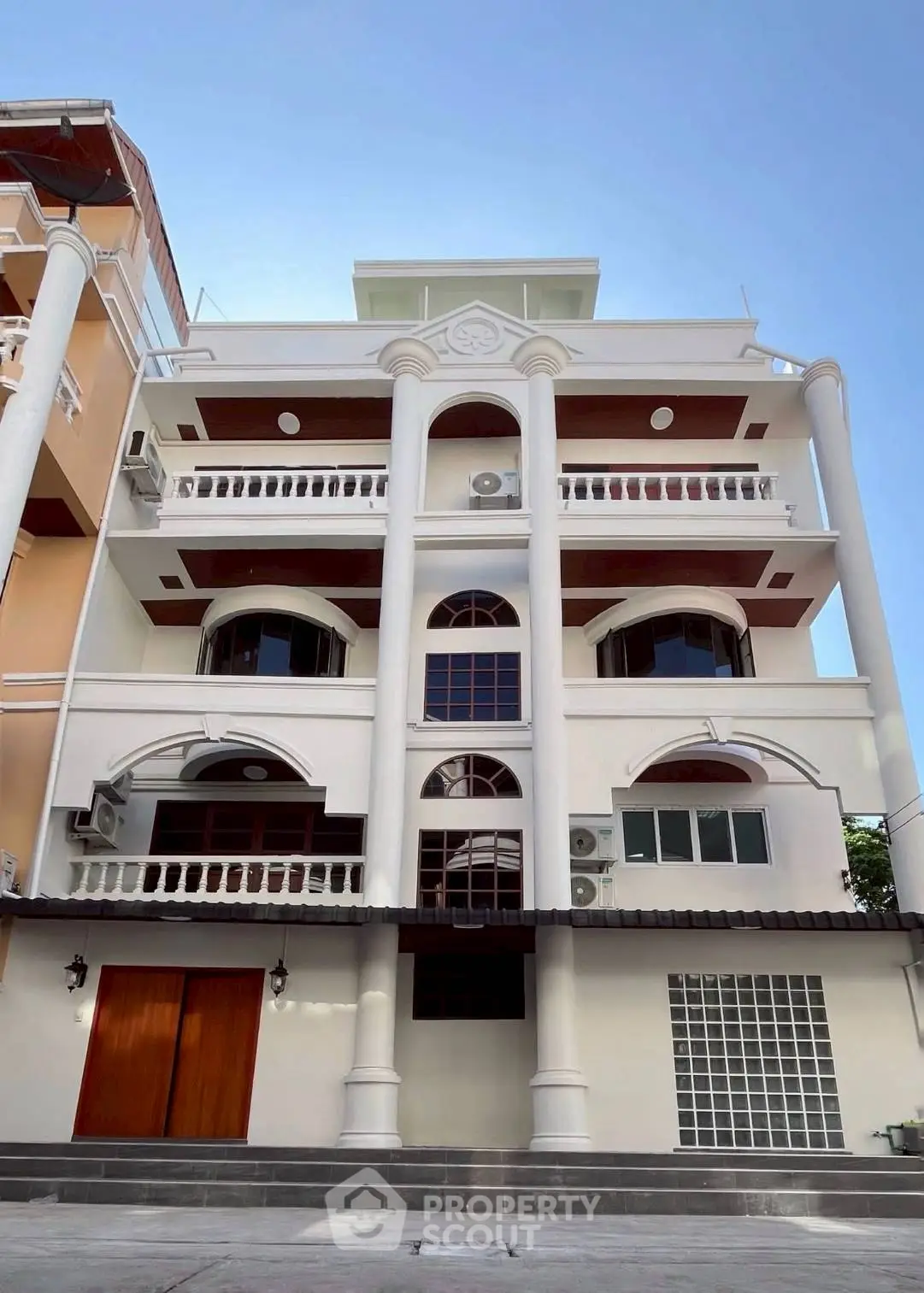 Elegant multi-story building with classic architectural columns and balconies.