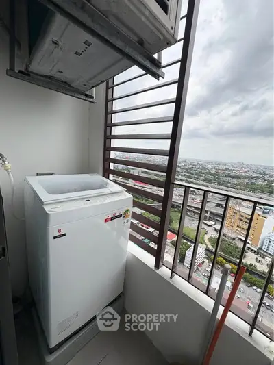High-rise apartment balcony with washing machine and city view