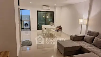 Spacious modern living room with sleek furniture and dining area