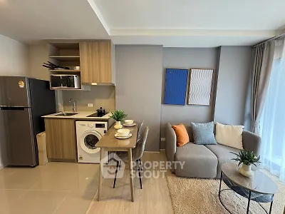 Modern open-layout kitchen and living room with stylish decor and appliances