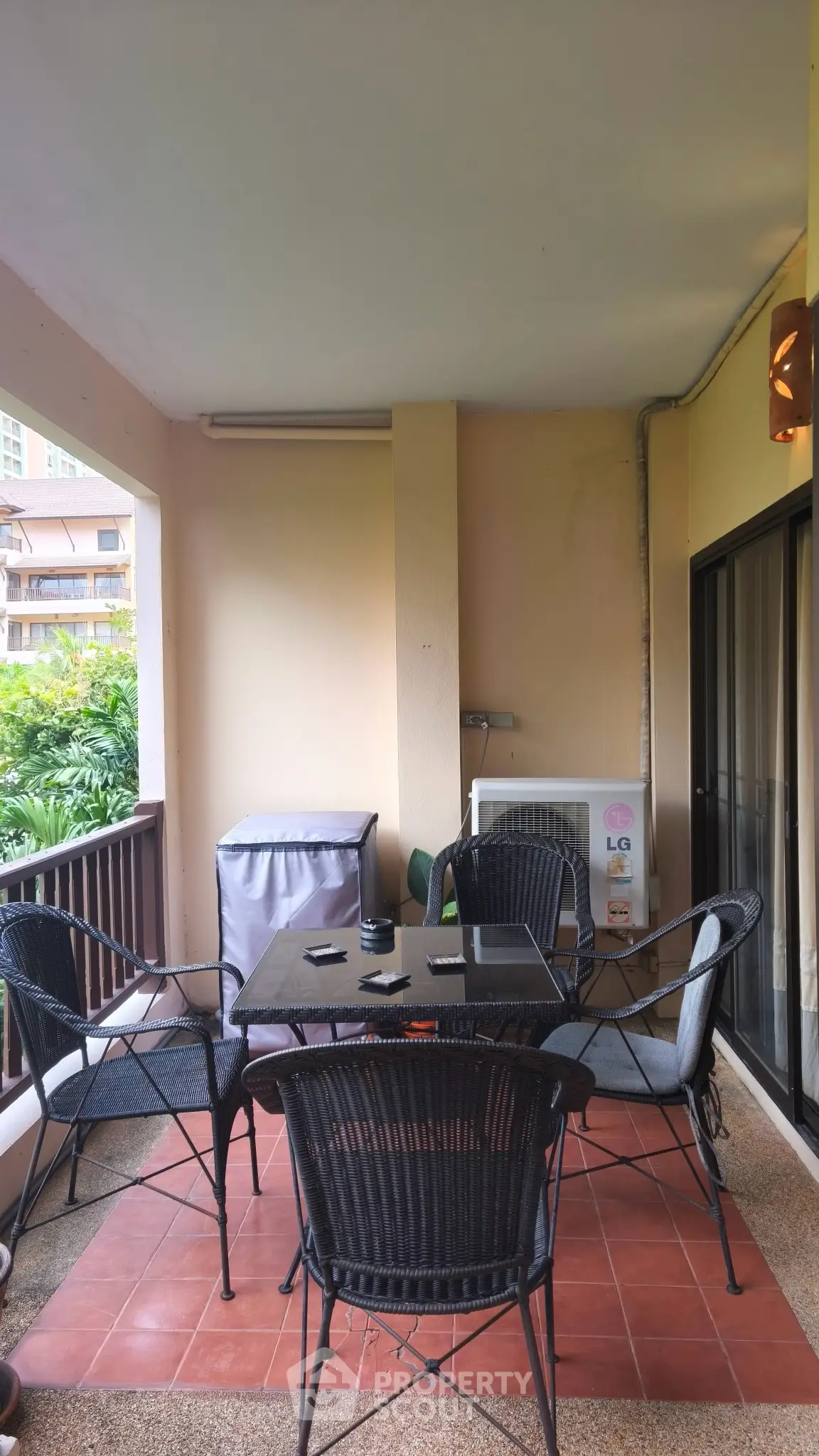 Charming balcony with outdoor seating and lush garden view, perfect for relaxation and entertaining.