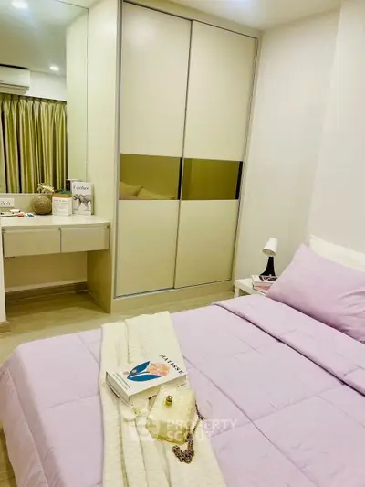 Cozy bedroom with modern decor, featuring a stylish wardrobe and elegant vanity area.