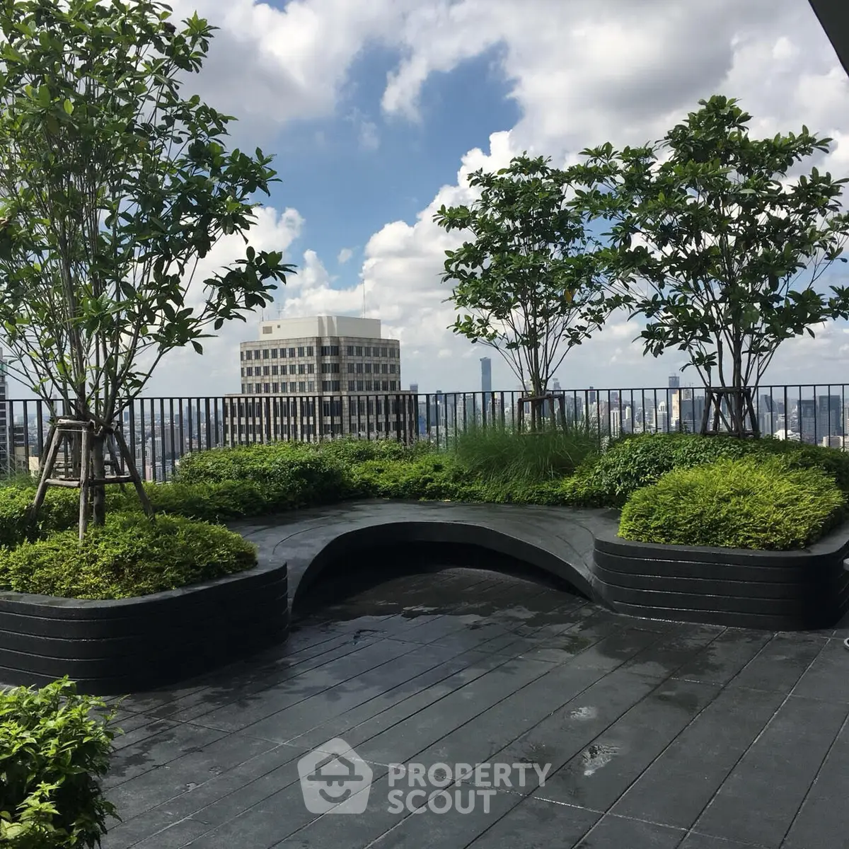 Stunning rooftop garden with city skyline views and lush greenery.
