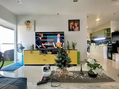 Spacious living room with modern decor and open kitchen layout