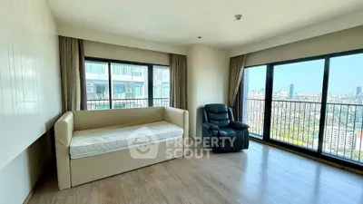 Spacious corner living room with panoramic city views and modern furnishings.