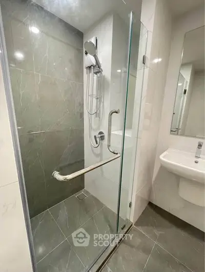 Modern bathroom with glass shower enclosure and sleek fixtures