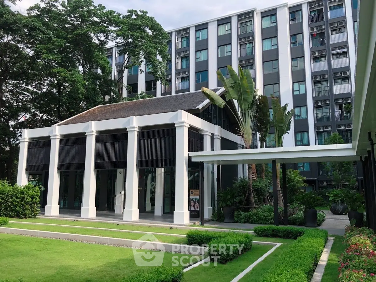 Modern apartment building with lush garden and elegant entrance