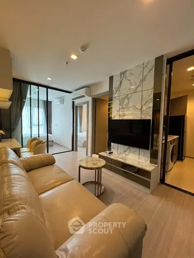 Modern living room with marble accent wall and open layout in luxury apartment
