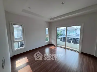 Spacious empty room with large windows and balcony access, perfect for customization.