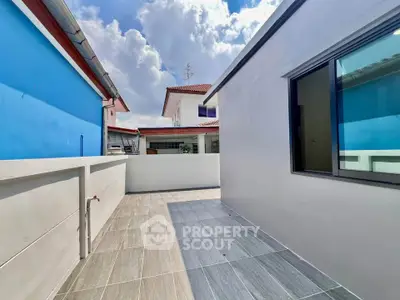 Spacious outdoor terrace with modern tiles and clear sky view