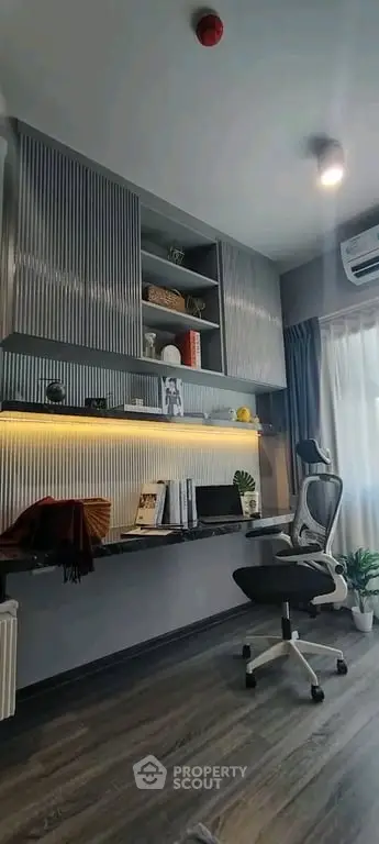 Modern study room with sleek desk, ergonomic chair, and stylish shelving in a contemporary apartment.