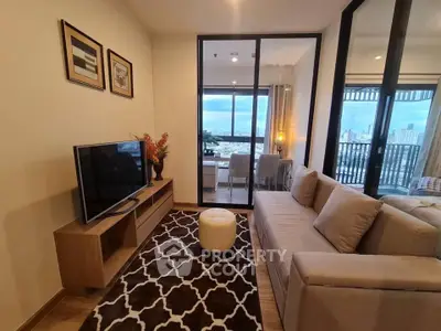 Modern living room with city view, stylish decor, and cozy seating area in a high-rise apartment.