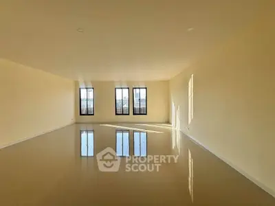 Spacious empty room with large windows and glossy tiled floor, perfect for customization.