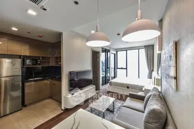 Modern open-plan living room with kitchen and bedroom in a stylish apartment