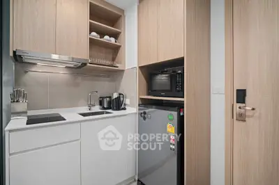Modern compact kitchen with sleek appliances and stylish cabinetry