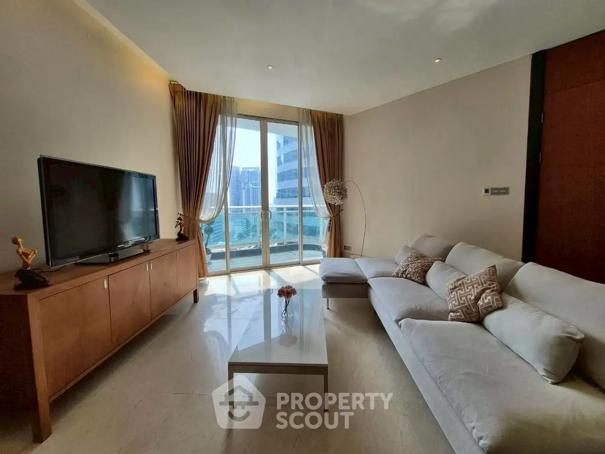 Luxurious living room with modern decor and stunning city view through large windows.