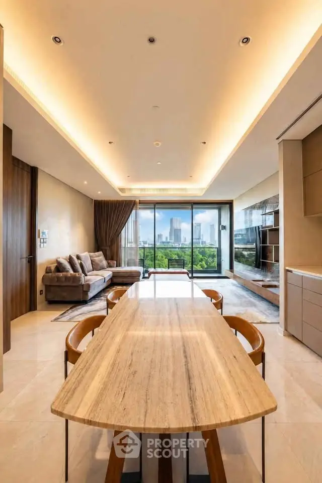Luxurious open-plan living room with stunning city view and elegant furnishings.