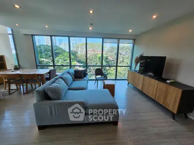 Spacious living room with panoramic city view and modern furnishings