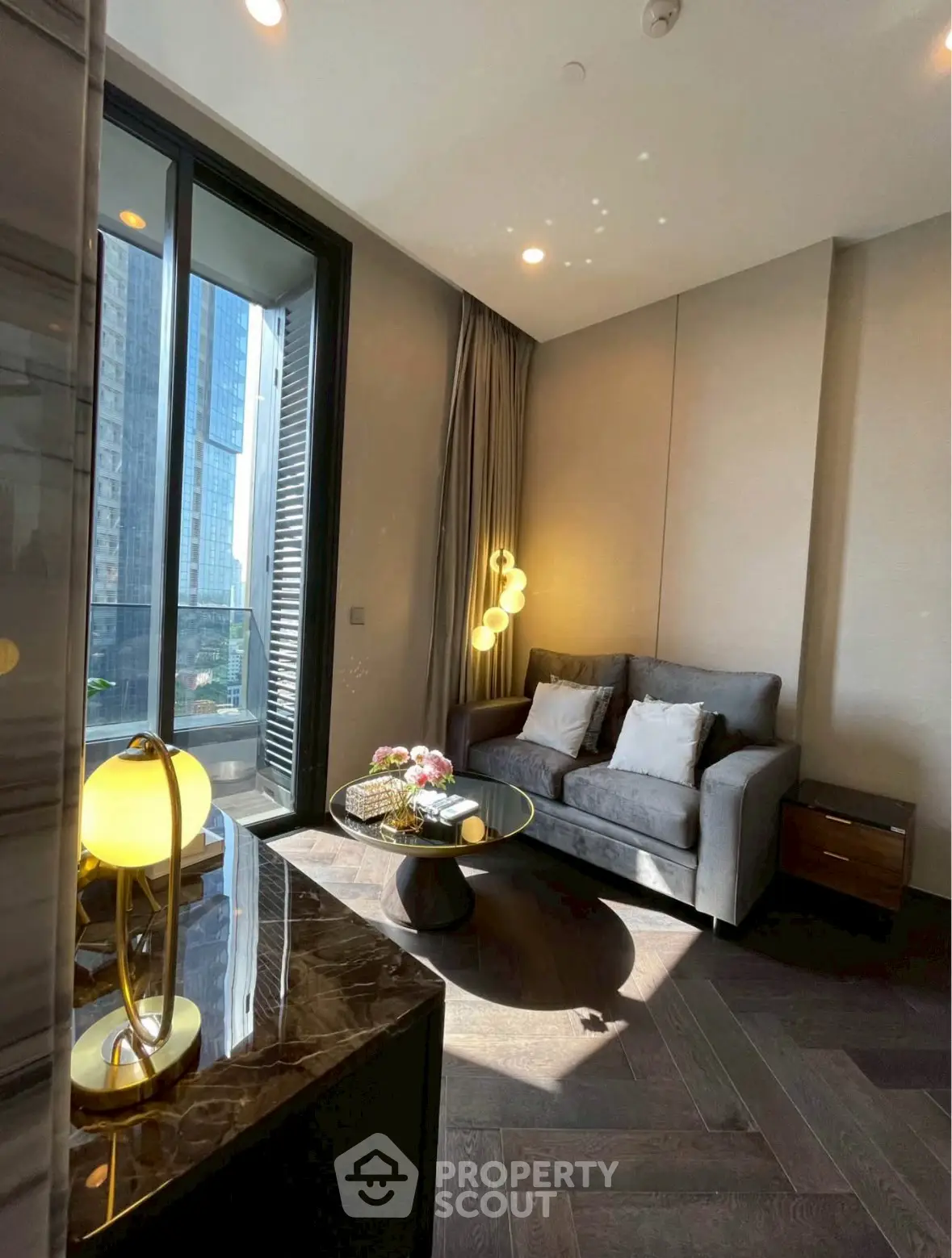 Luxurious living room with modern decor and large windows offering city views.