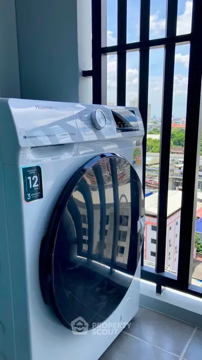Modern washing machine on balcony with city view, perfect for urban living convenience.