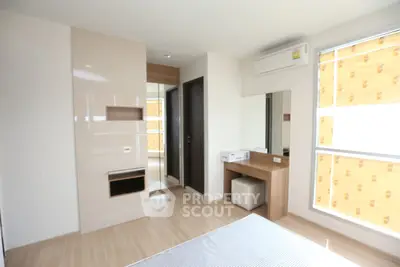 Bright and modern bedroom with large windows and sleek wooden flooring.
