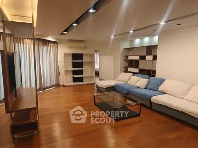 Spacious modern living room with wooden flooring and stylish furniture