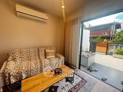 Cozy living room with air conditioning and outdoor patio access