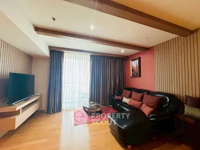 Stylish living room with modern decor, wooden flooring, and cozy seating area.