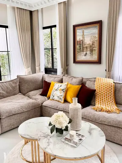 Elegant living room with plush sectional sofa and chic decor accents.