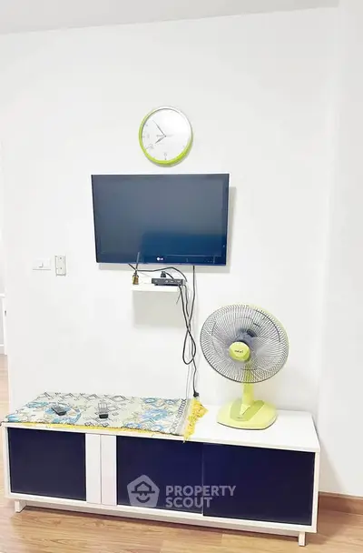 Modern living room with wall-mounted TV and stylish decor