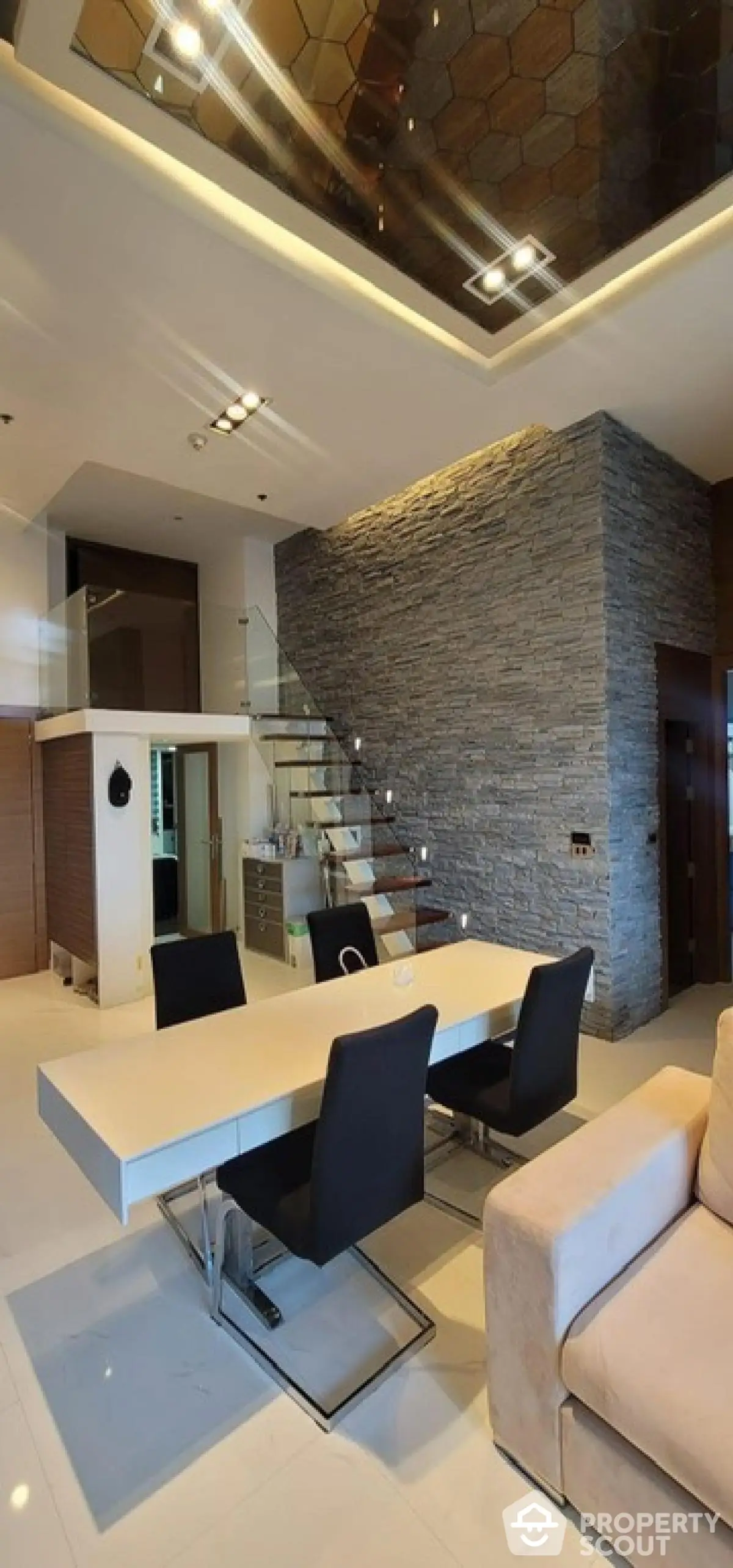 Luxurious modern living room with elegant staircase and stylish dining area