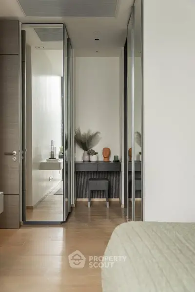 Modern bedroom with mirrored closet and stylish decor