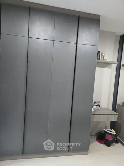 Modern storage space with sleek cabinets and built-in shelves in a contemporary home.