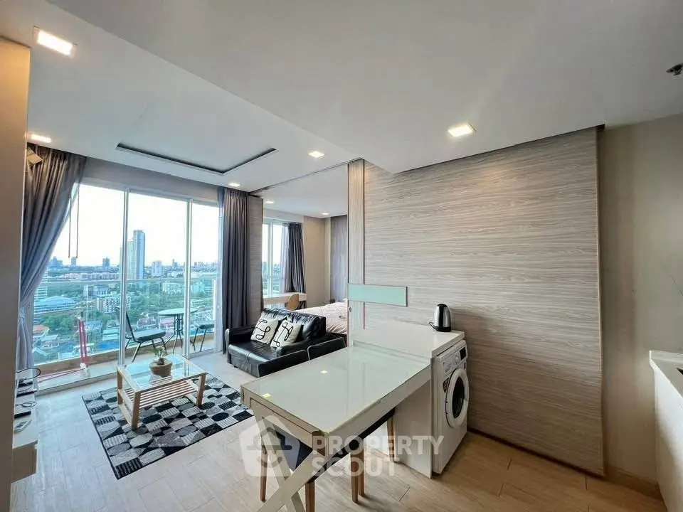 Modern living room with city view, stylish decor, and natural light in urban apartment.