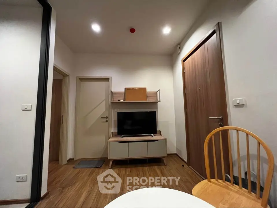 Modern living room with wooden flooring and stylish furniture in a cozy apartment.