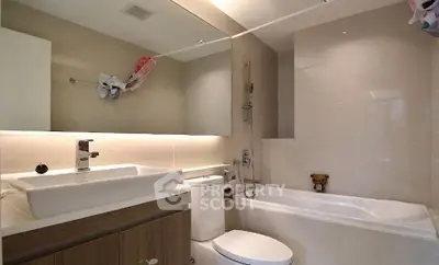 Modern bathroom with sleek fixtures and bathtub in contemporary home.