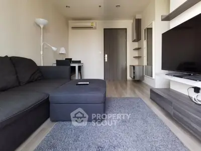 Modern living room with sleek furniture and TV setup, perfect for relaxation and entertainment.