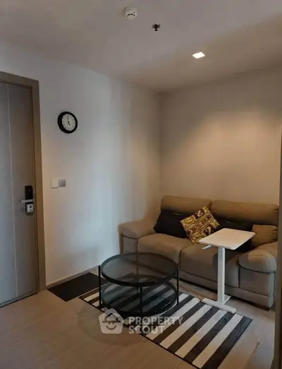 Cozy living room with modern sofa, glass coffee table, and stylish decor.