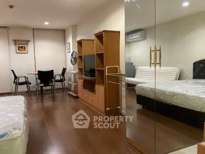 Spacious studio apartment with modern furnishings and wooden flooring