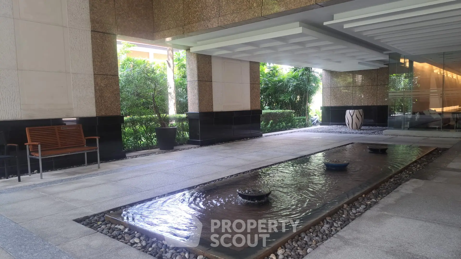 Luxurious building entrance with elegant water feature and modern design