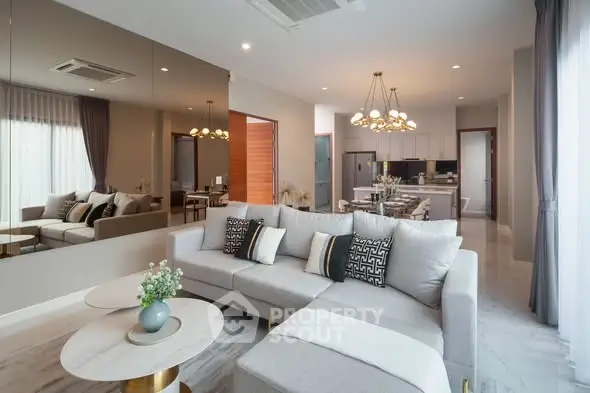Luxurious modern living room with elegant decor and open kitchen layout, perfect for stylish urban living.