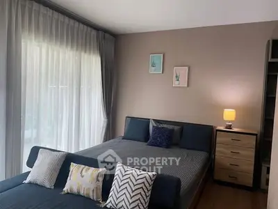 Cozy bedroom with modern decor and ample natural light