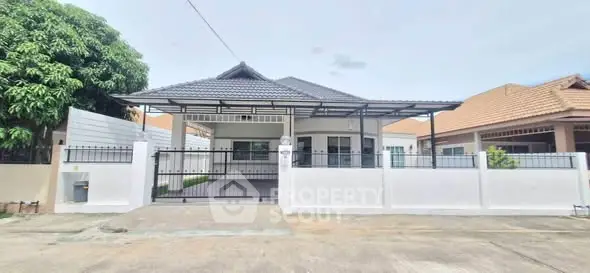 Charming single-story house with modern design and spacious driveway in a serene neighborhood.