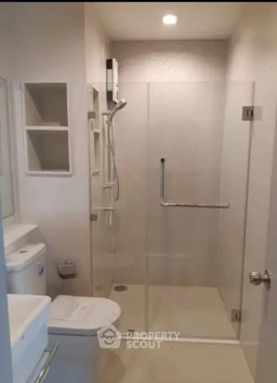 Modern bathroom with glass shower enclosure and sleek fixtures