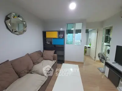 Cozy living room with modern decor and ample natural light in urban apartment