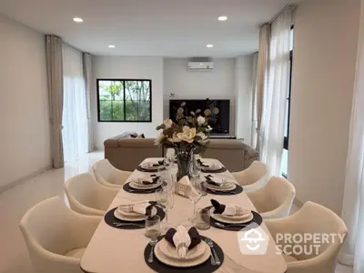 Elegant dining area with modern decor and cozy living room in open layout