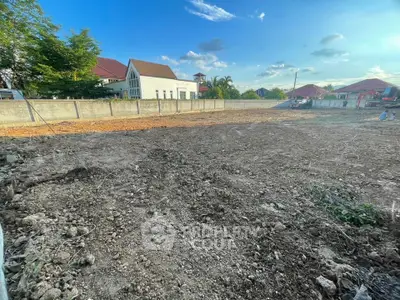 Vacant land plot with clear blue sky, ideal for new construction opportunities.