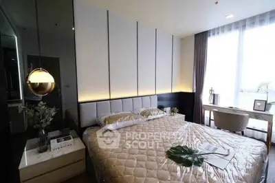 Luxurious bedroom with modern decor and large window for natural light.