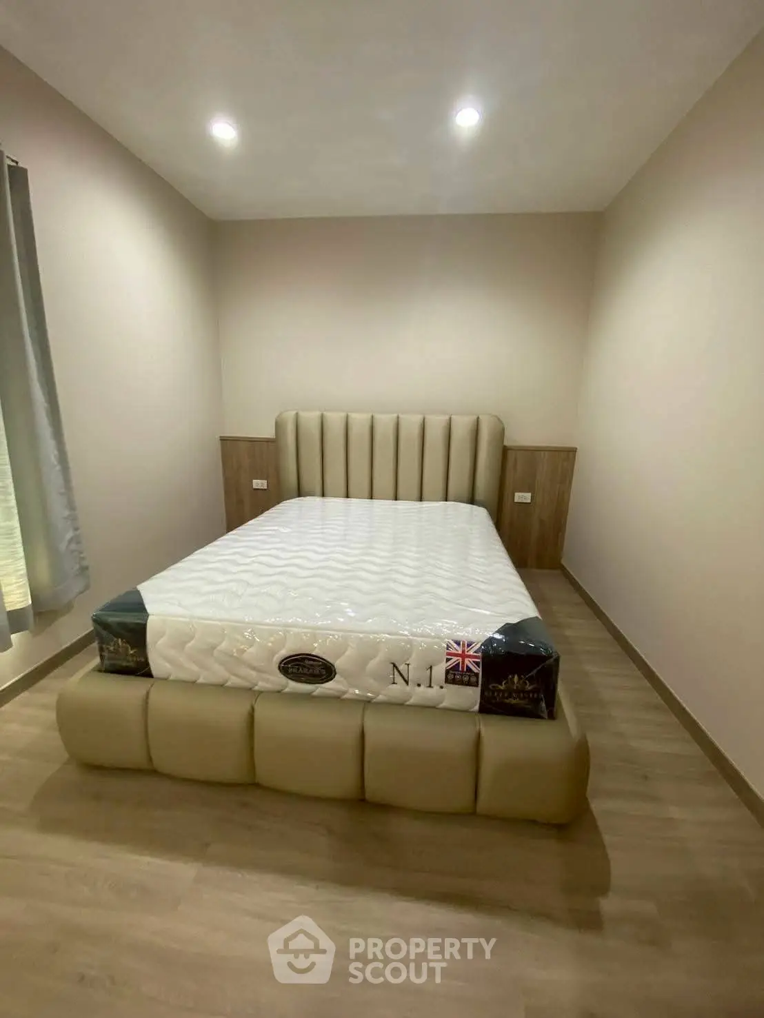 Modern bedroom with stylish bed and wooden flooring, perfect for a cozy retreat.