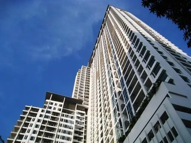 Stunning modern high-rise building with sleek architecture against a clear blue sky.